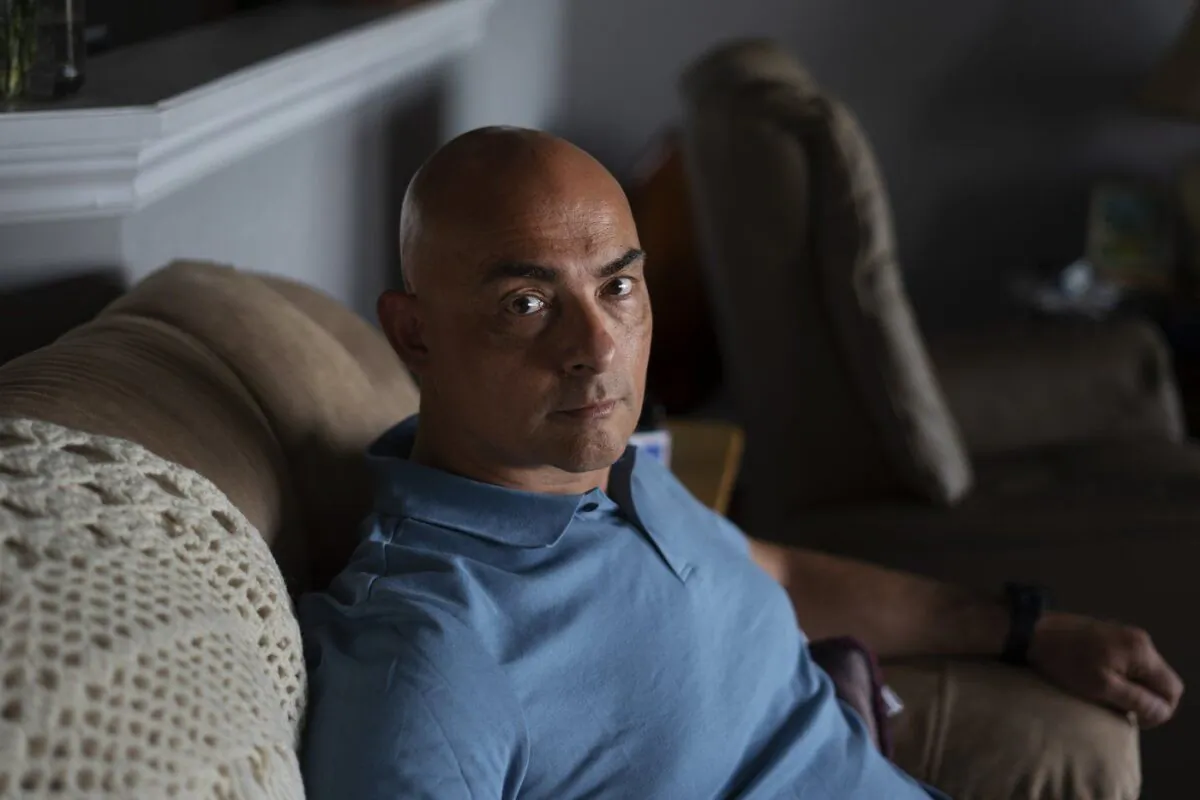 Mark Zawidzki, a volunteer firefighter, poses at the temporary apartment where he and his family are staying in Halifax on June 1, 2023. (The Canadian Press/Darren Calabrese)