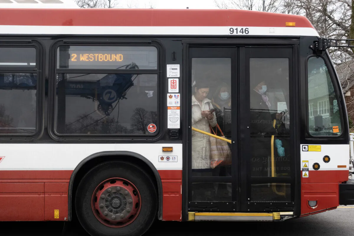 People ride on a shuttle bus outside a west-end Toronto subway stop after subway service was closed during the morning commute on April 5, 2023. (THE CANADIAN PRESS/Graeme Roy)