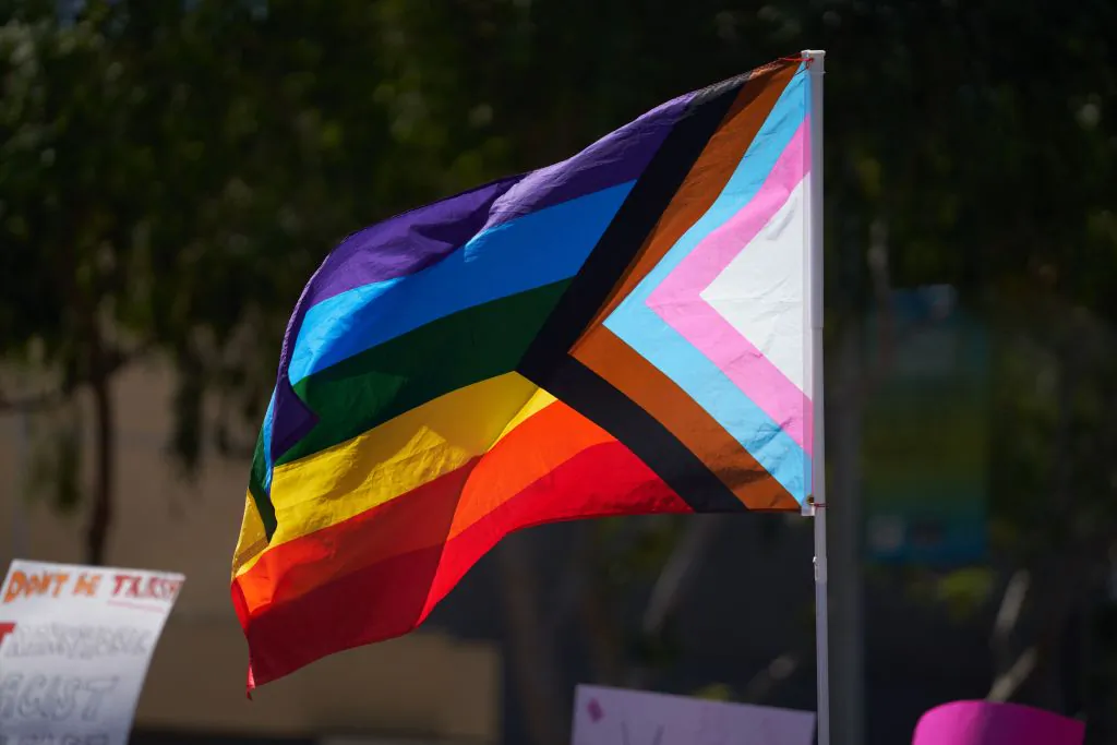 A pride flag is held above the crowd of LGBT activists during a rally in West Hollywood, Calif., on April 9, 2023. (Allison Dinner/AFP via Getty Images)