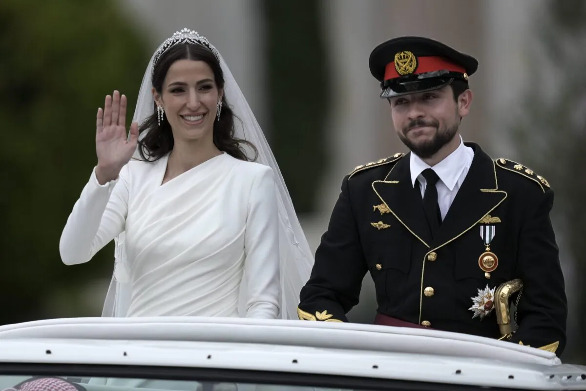 Jordan's Crown Prince Hussein and Saudi Rajwa Alseif wave to well-wishers during their wedding ceremonies in Amman, Jordan, on June 1, 2023. (Nasser Nasser/AP Photo)