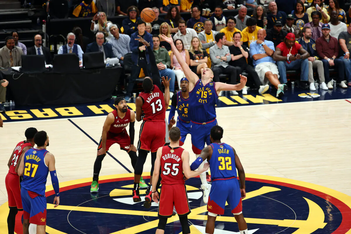 Bam Adebayo (13) of the Miami Heat tips off against Nikola Jokic (15) of the Denver Nuggets during the fourth quarter in Game One of the 2023 NBA Finals at Ball Arena in Denver on June 1, 2023. (Jamie Schwaberow/Getty Images)
