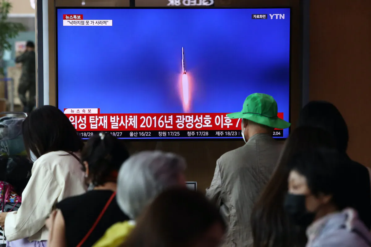 People watch a television broadcast showing a file image of a North Korean rocket launch at the Seoul Railway Station on May 31, 2023. North Korea fired what it claims to be a "space launch vehicle" southward but it fell into the Yellow Sea after an "abnormal" flight, the South Korean military said, in a botched launch that defied international criticism and warnings. (Chung Sung-Jun/Getty Images)