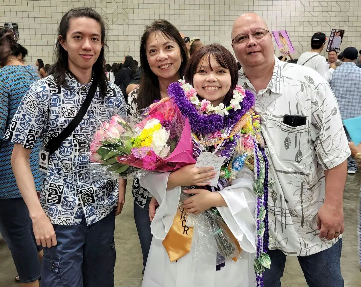 Jarek Agcaoili (L), with his mother Danielle, sister Jessika, and father Maury Agcaoili pose at Jessika's high school graduation in Hawaii in May 2023. (Vernon Tyau via AP)