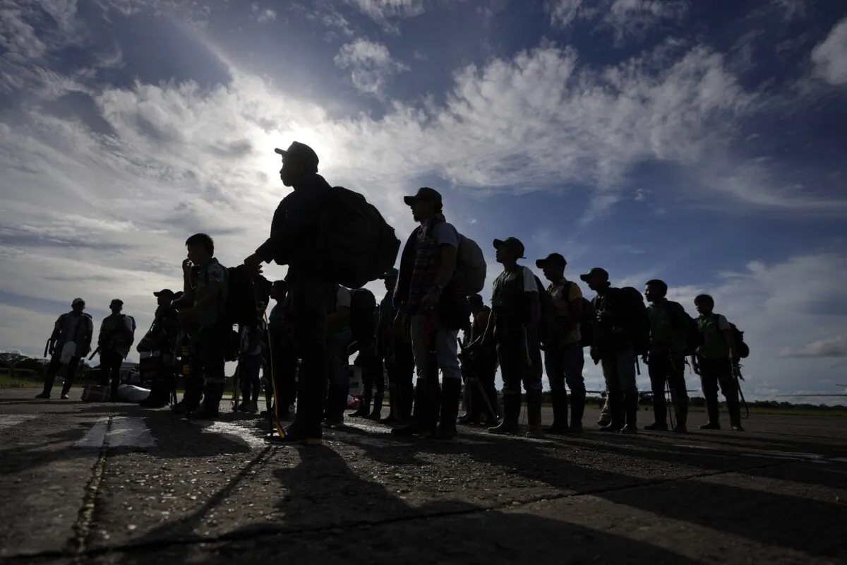Indigenous people line up upon arrival at the airport in San Jose del Guaviare, Colombia, on May 21, 2023, to help search for four Indigenous children missing after a deadly plane crash. (Fernando Vergara/AP Photo)