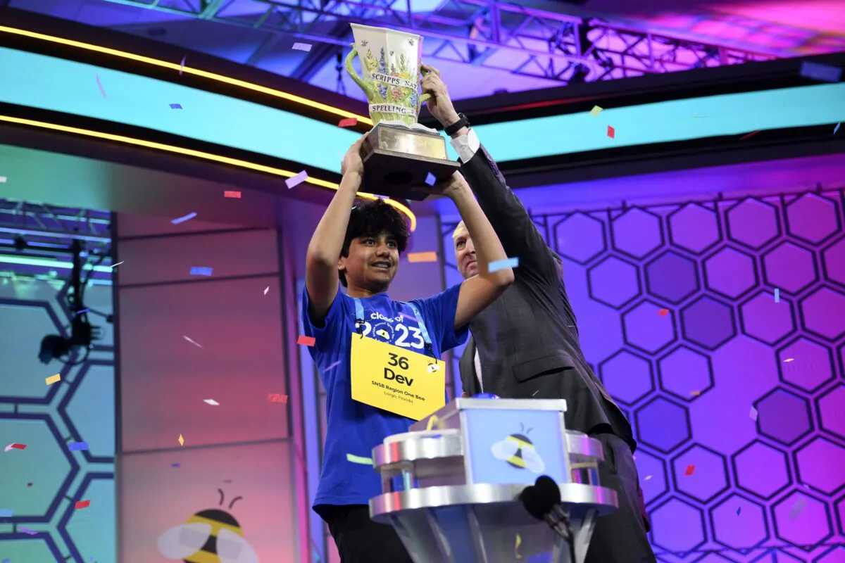 Dev Shah, 14, from Largo, Fla., lifts the trophy next to Scripps CEO Adam Symson after he won the Scripps National Spelling Bee finals in Oxon Hill, Md., on June 1, 2023. (Nick Wass/AP Photo)