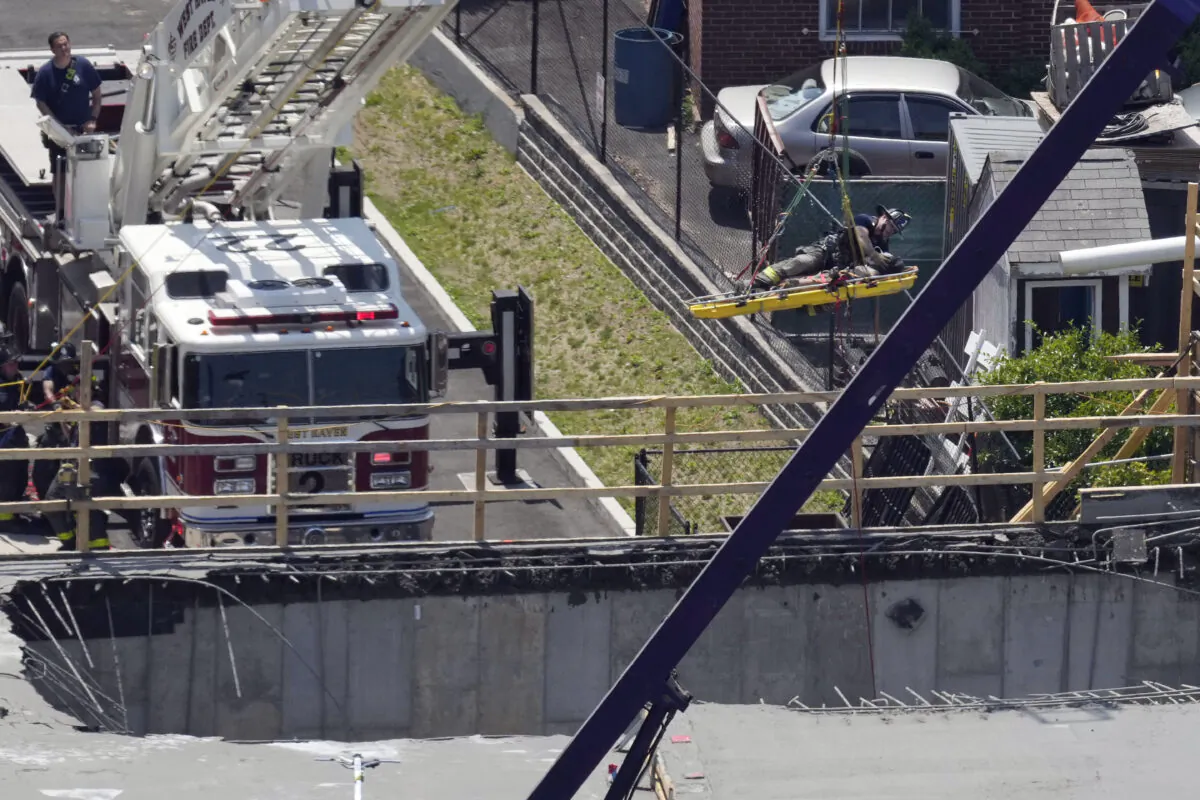 Firefighters rescue a worker after the partial collapse of a building under construction in New Haven, Conn., on June 2, 2023. (Paul Haring via AP)