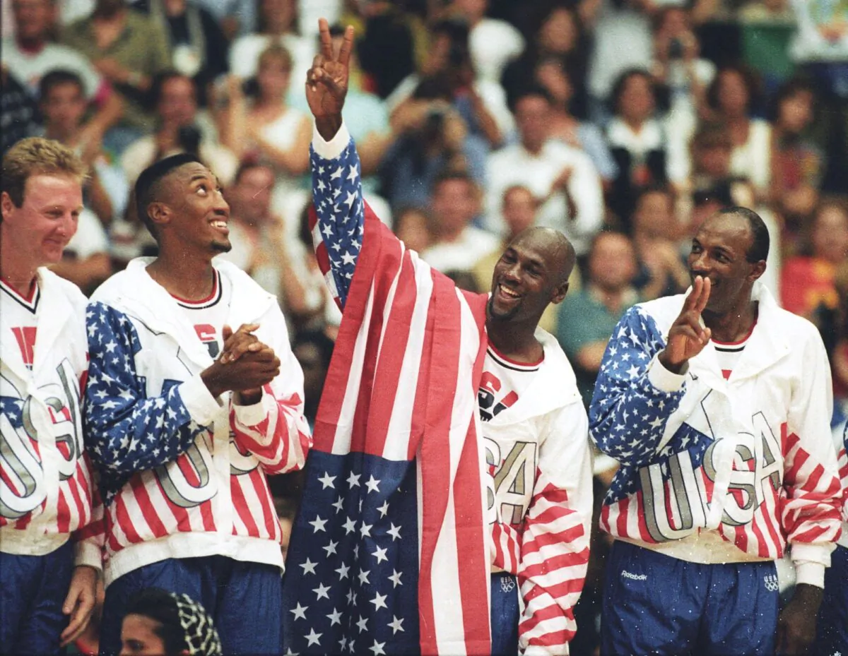 U.S. basketball player Michael Jordan (2nd R) flashes a victory sign as he stands with team mates Larry Bird (L), Scottie Pippen and Clyde Drexler (R), nicknamed the "Dream Team" after winning the Olympic gold in Barcelona, Spain, on Aug. 8, 1992. (Ray Stubblebine/Reuters)