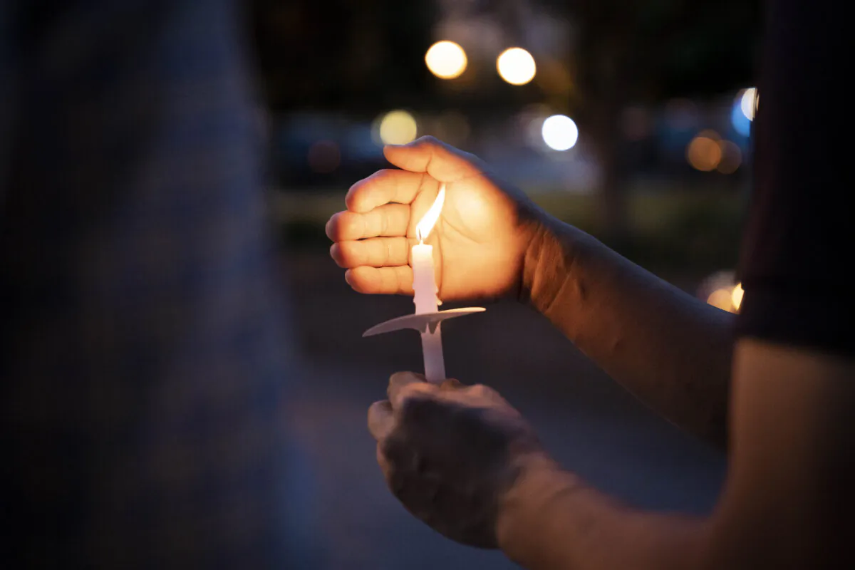 A person holds a candle at a candlelight vigil in Washington on June 2, 2023, mourning the victims of the 1989 Tiananmen Square massacre. (Madalina Vasiliu/The Epoch Times)