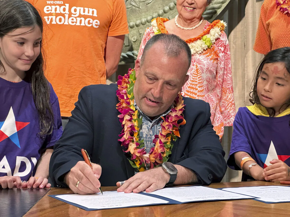 Hawaii Gov. Josh Green signs gun control legislation in Honolulu, Hawaii, on June 2, 2023. (Audrey McAvoy/AP Photo)