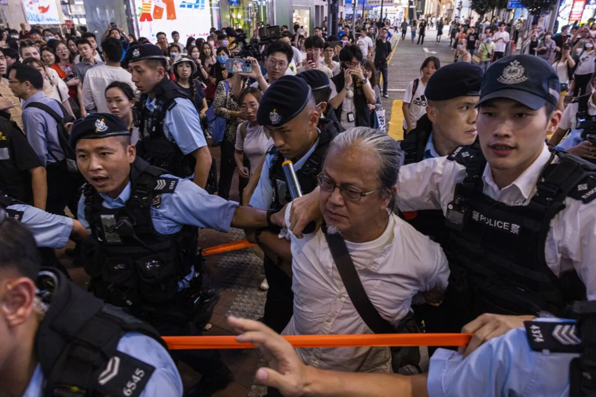 A member of the public is taken away by the police in the Causeway Bay area on the eve 34th anniversary of the Tiananmen Square massacre, in Hong Kong on June 3, 2023. (Louise Delmotte/AP Photo)