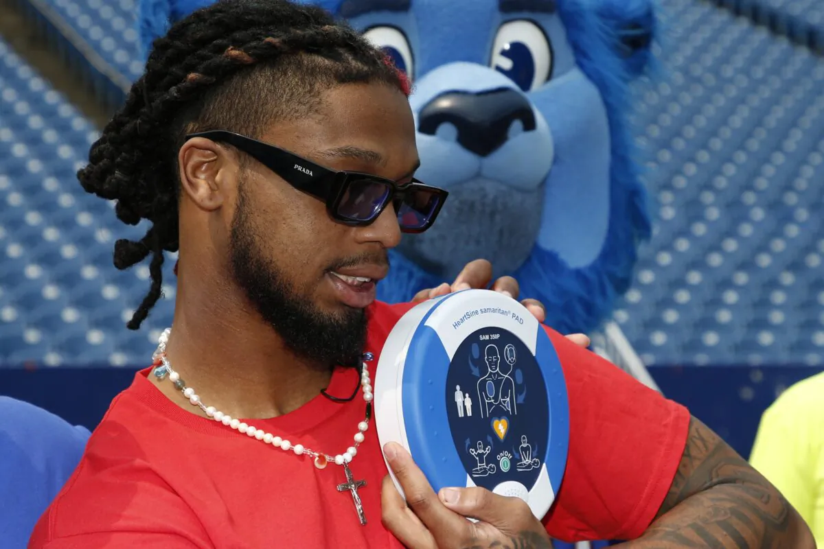 Buffalo Bills defensive back Damar Hamlin poses with a AED (Automatic Electronic Defibrillator) to help resuscitate heart attack victims, to local community groups following the announcement of the first program of his Chasing M's Foundation, the Chasing M's Foundation CPR Tour, in Orchard Park, N.Y., on June 3, 2023. (Jeffrey T. Barnes/AP Photo)