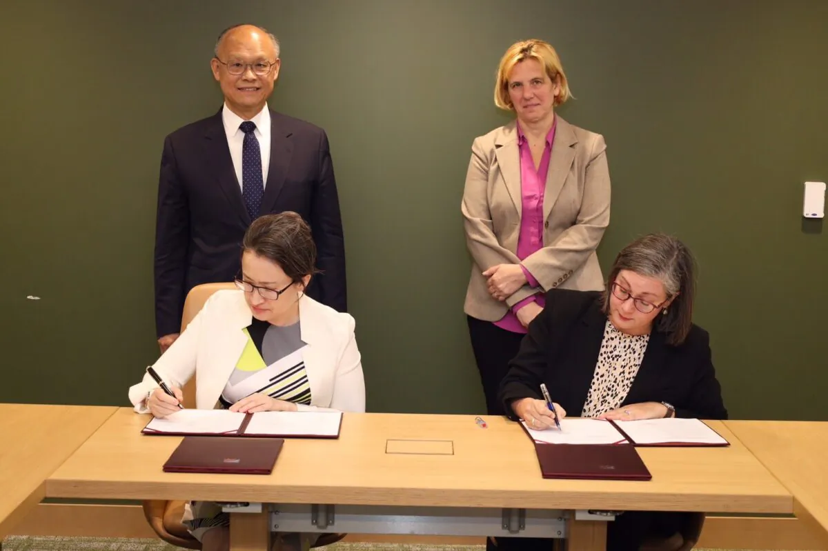 Taiwan's Ambassador to the United States Hsiao Bi-khim (front L) and managing director of the American Institute in Taiwan's headquarters Ingrid Larson (front R) sign a trade agreement as minister without portfolio in charge of the Office of Trade Negotiations John Deng (back L) and deputy U.S. Trade Representative Sarah Bianchi (back R) look on, in Arlington, Va., on June 1, 2023. (Taipei Economic and Cultural Representative Office)