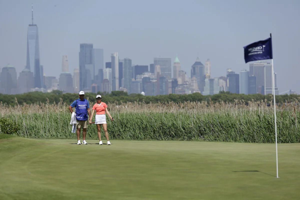 Rose Zhang of the United States and her caddie line up a shot on the 14th green during the second round of the Mizuho Americas Open at Liberty National Golf Club in Jersey City, N.J., on June 2, 2023. (Adam Hunger/Getty Images)
