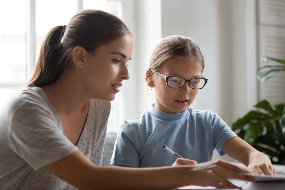 By taking 15 minutes to go over your student's schoolwork every day, you can keep an eye on his or her progress. (fizkes/Shutterstock)