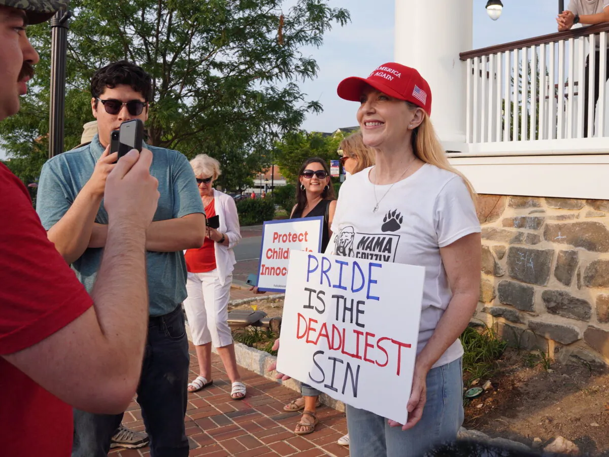 Fairfax mother Stacy Langton (R) protests a Pride month event featuring drag queen performances outside the old town hall in Fairfax, Va., on Jun. 3, 2023. (Terri Wu/The Epoch Times)