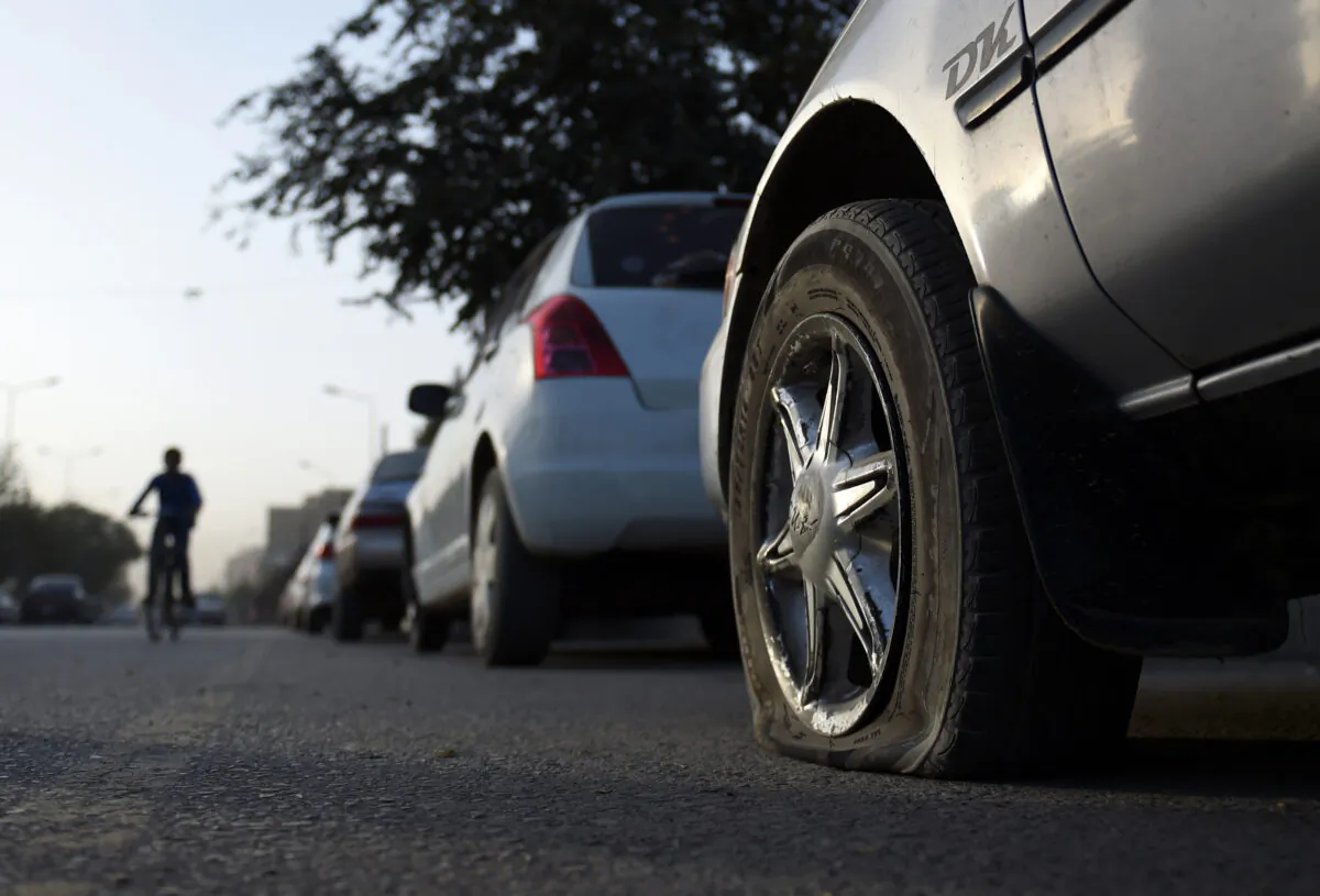 A car with deflated tires is parked on a street in Kabul in this Sept. 25, 2016, file photo. 
(Wakil Koshar/AFP via Getty Images)