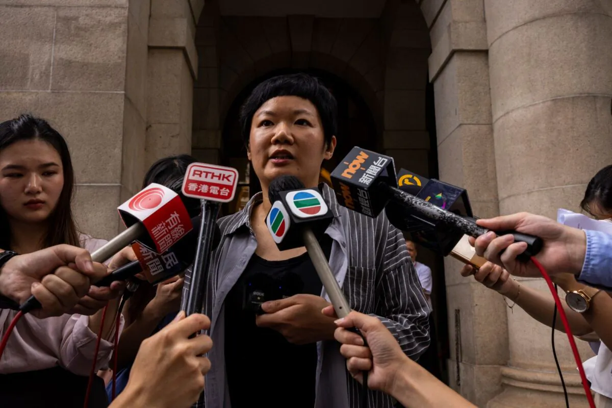 Journalist Bao Choy, (C), speaks to members of the press after being cleared by Top Hong Kong court in Hong Kong, on June 5, 2023. (Louise Delmotte/AP Photo)