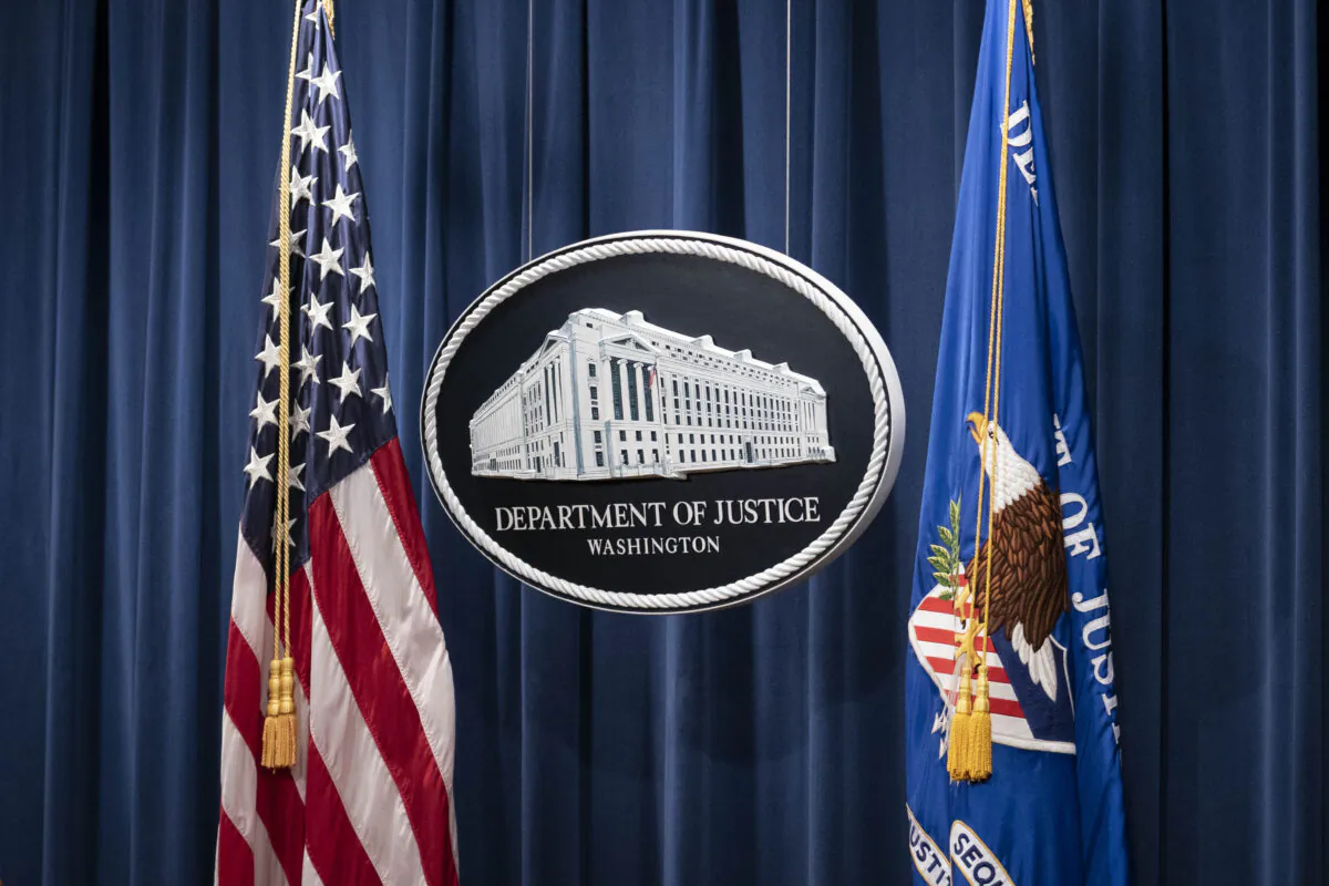 A sign for the Department of Justice is seen ahead of a news conference with Michael Sherwin, acting US attorney for the District of Columbia, and Steven D'Antuono, head of the Federal Bureau of Investigation (FBI) Washington field office, at the US Department of Justice in Washington, DC, on January 12, 2021. (SARAH SILBIGER/POOL/AFP via Getty Images)