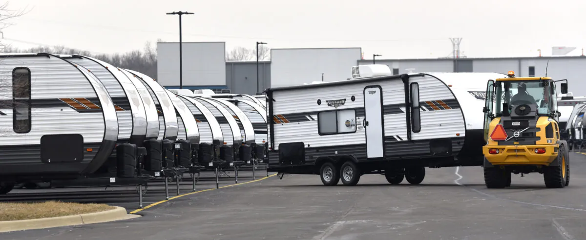 An RV porter moves travel trailers into place as General RV prepares for their sales event as customers prepare for another camping season, in Wixom, Michigan, on March 15, 2022. (Todd McInturf/The Detroit News/TNS)