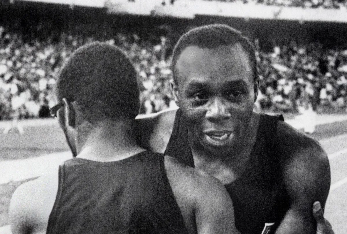 American champion Jim Hines (R) is congratulated by his compatriot Charles Green upon his Olympics 100m victory, clocking a time of 9.9 in Mexico City, on 14 Oct.1968. (Staff/AFP via Getty Images)