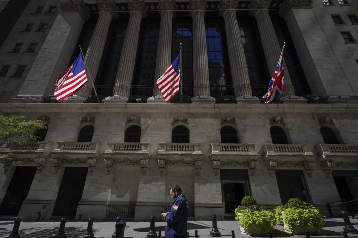 A trader looks over his cell phone outside the New York Stock Exchange in the financial district of Manhattan in New York on Sept. 14, 2022. (Mary Altaffer/AP Photo)