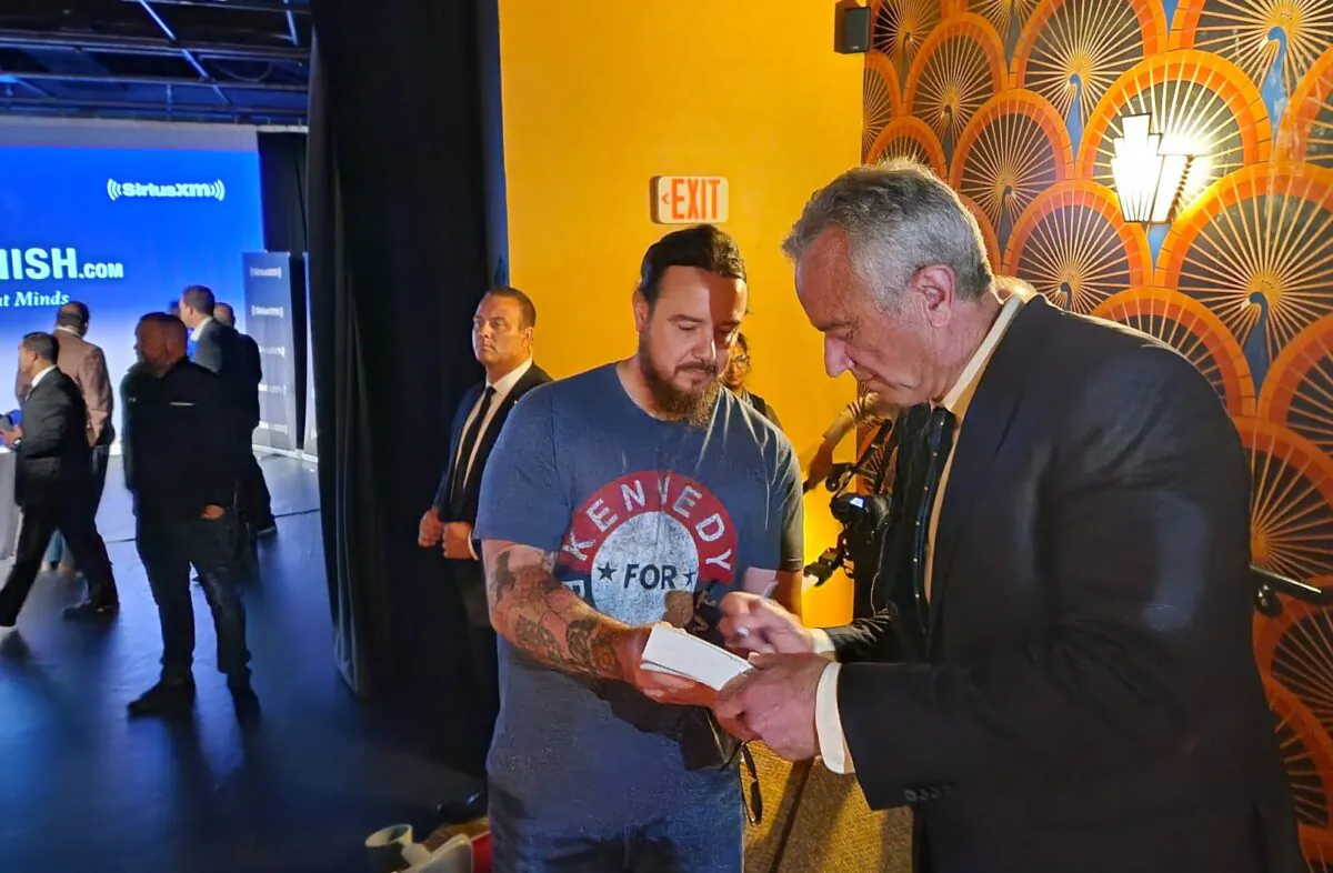 Robert F. Kennedy Jr. with U.S. Marine Corps veteran James Taulbee after the June 5 town hall. (Jeff Louderback/The Epoch Times)