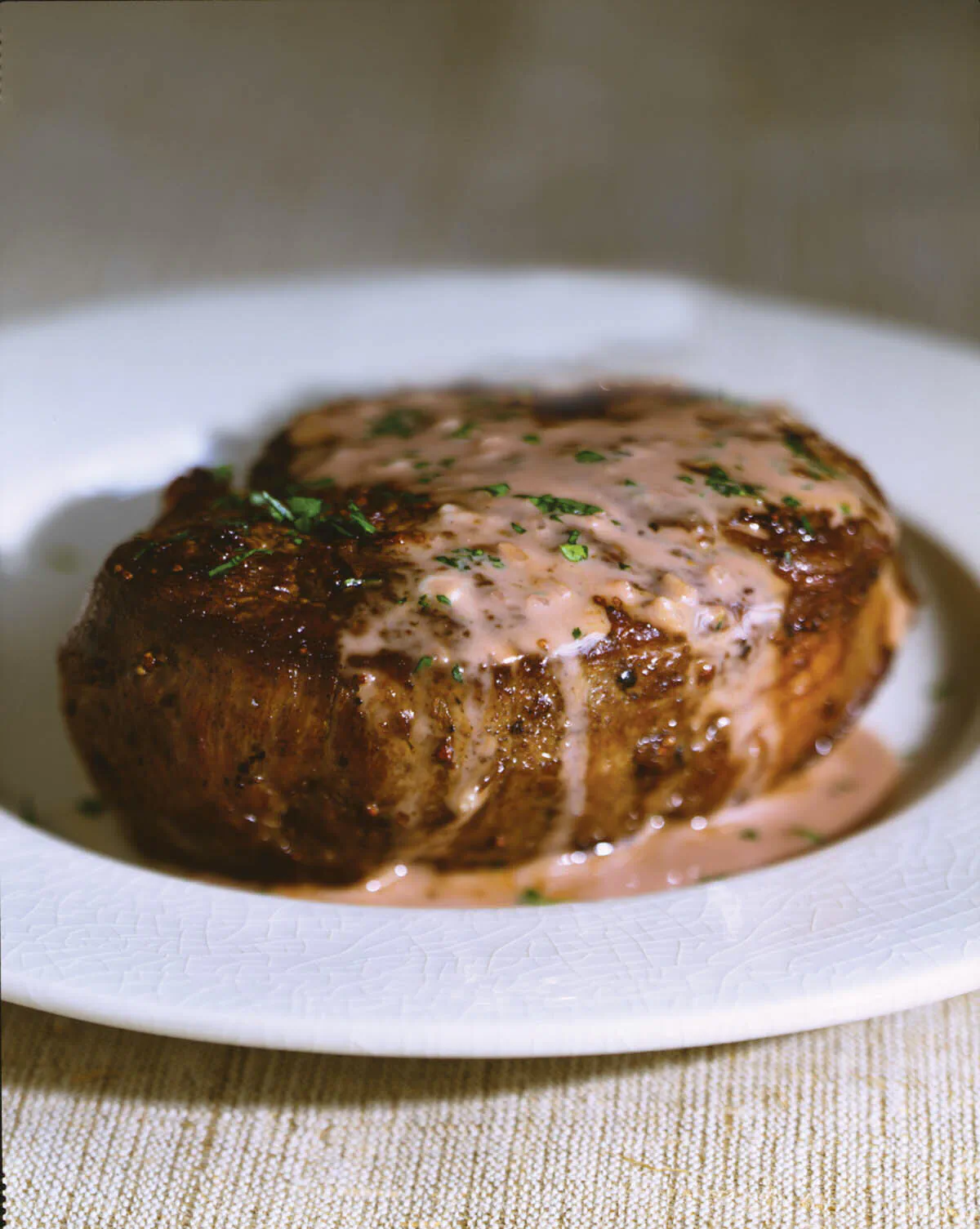 A tender filet of beef is accompanied by a cheesy, creamy sauce. (Maren Caruso/TNS)