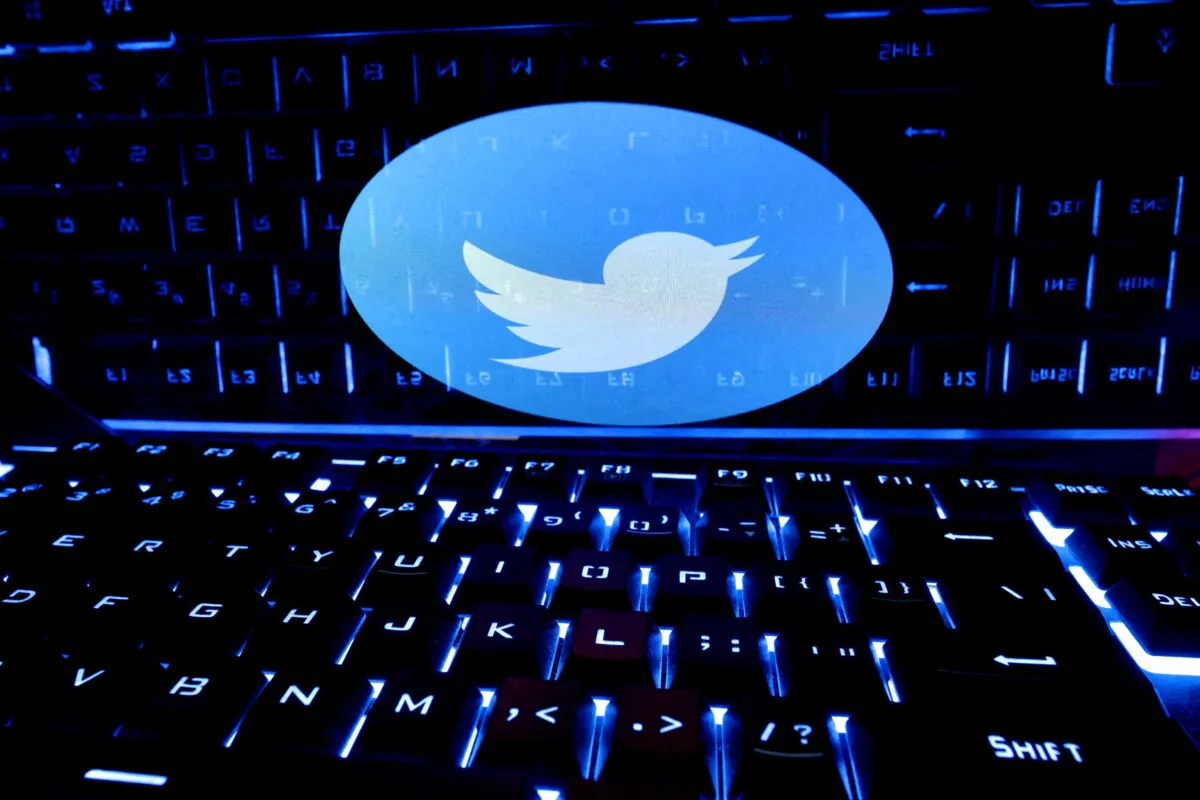 A keyboard is placed in front of a Twitter logo on Feb. 21, 2023. (Dado Ruvic/Reuters)