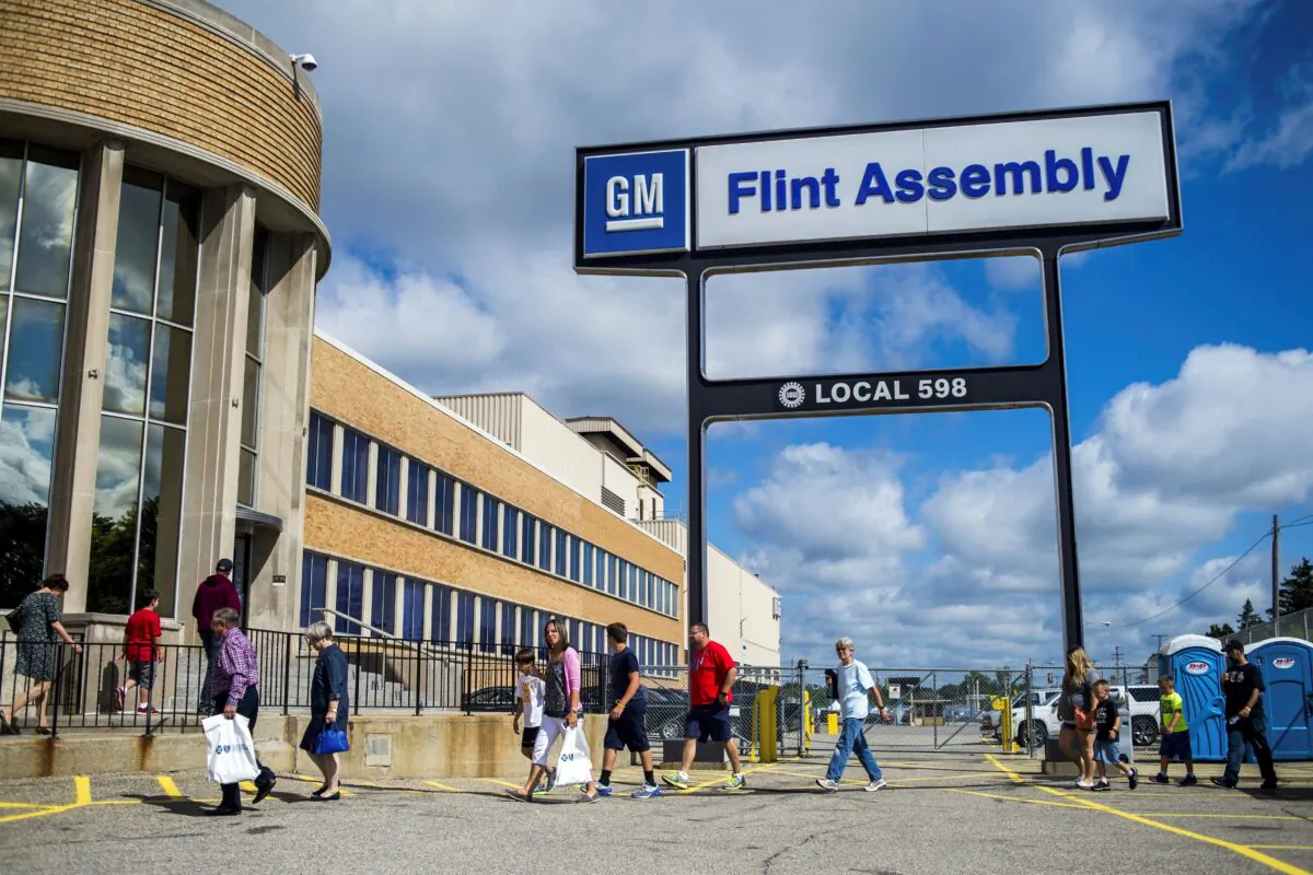 People arrive at the Flint Assembly Plant for a free tour and open house in Flint, Mich., on Aug. 11, 2015. (Jake May/The Flint Journal via AP)
