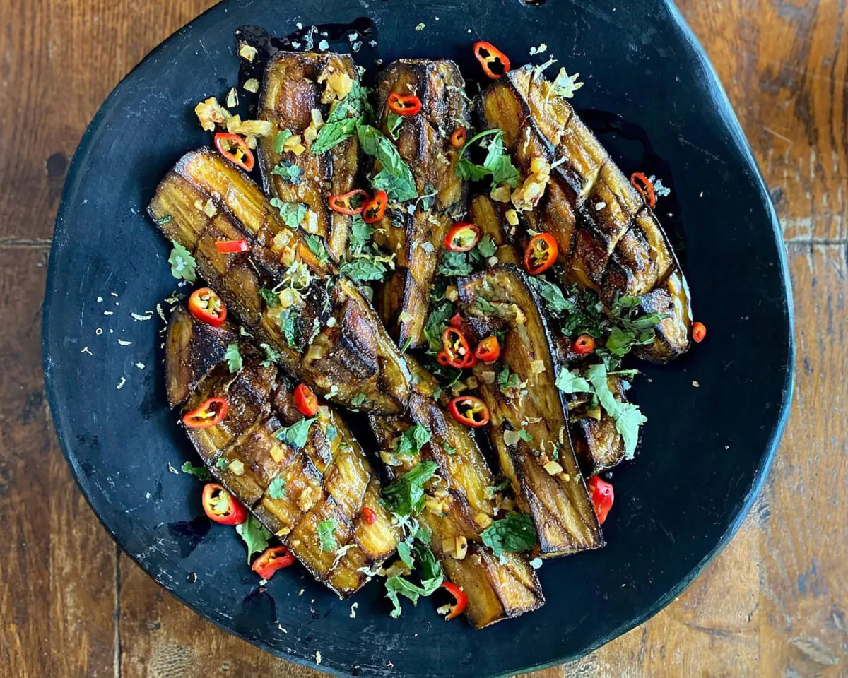 Soft, buttery wedges of grilled eggplant are doused in a flavorful spiced oil and topped with a bright, herbaceous gremolata. (Lynda Balslev for Tastefood)
