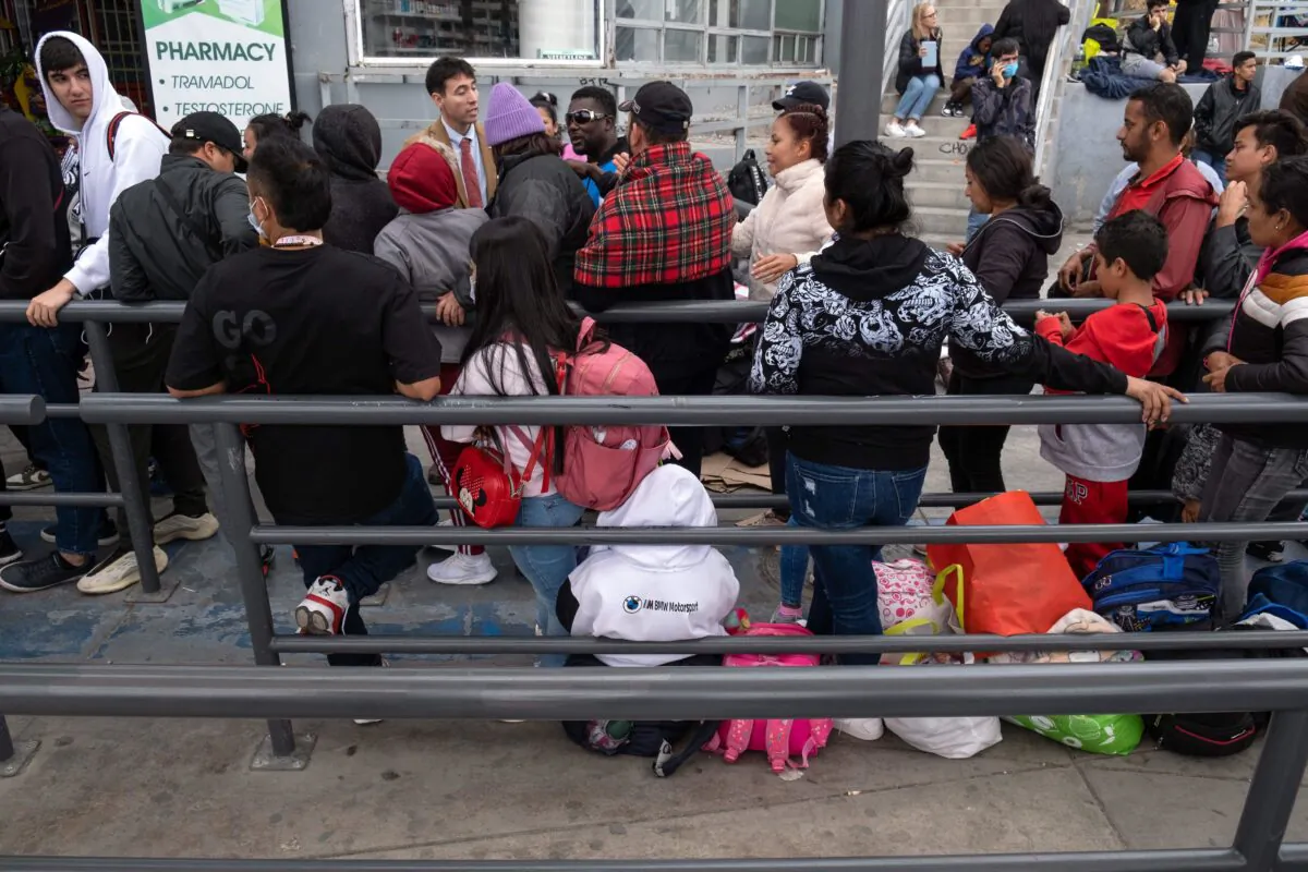 Illegal immigrants wait for U.S. Customs and Border Protection agents to allow them enter the country at the San Ysidro crossing port on the U.S.-Mexico border, as seen from Tijuana, Baja California state, Mexico, on May 31, 2023. (Guillermo Arias/AFP via Getty Images)