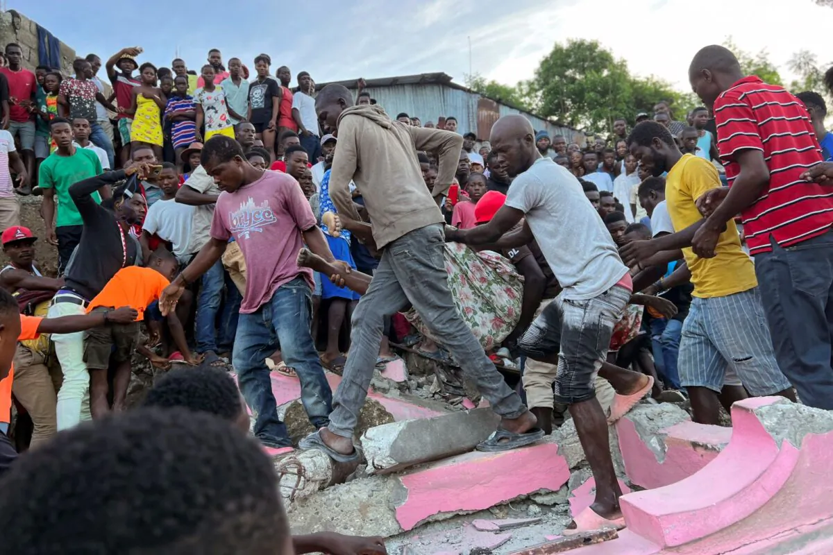 People carry an injured person away from a home that collapsed due to an earthquake in Jeremie, Haiti, on June 6, 2023. (Ralph Simon/AP Photo)