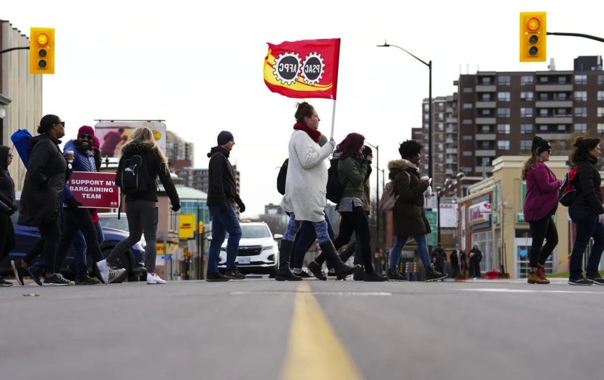 PSAC workers and supporters picket in front of President of the Treasury Board Mona Fortier's office in Ottawa on April 21, 2023. (The Canadian Press/Sean Kilpatrick)
