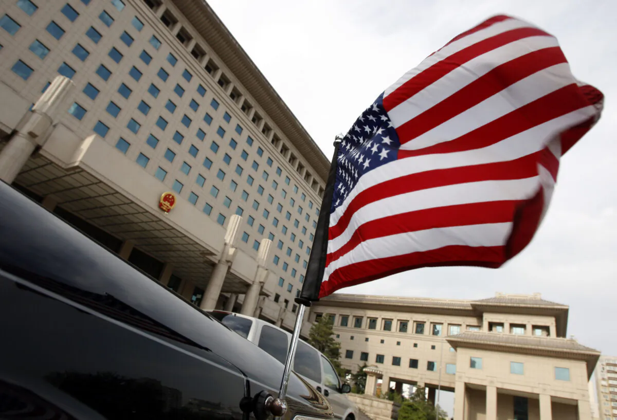 The U.S. flag flies from an embassy car outside China's Ministry of Defense in Beijing on June 24. (Greg Baker - Pool/Getty Images)