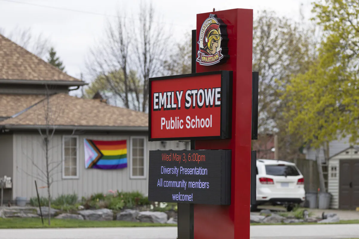 A sign for Emily Stowe Public School is seen with the pride flag in the background in Norwich, Ont., on May 3, 2023. (The Canadian Press/Nicole Osborne)