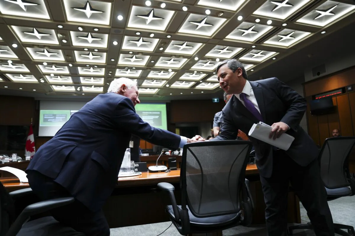 Conservative MP Michael Chong shakes hands with David Johnston, independent special rapporteur on foreign interference, who appears as a witness at the Procedure and House Affairs Committee on Parliament Hill in Ottawa on June 6, 2023. (Sean Kilpatrick/The Canadian Press)