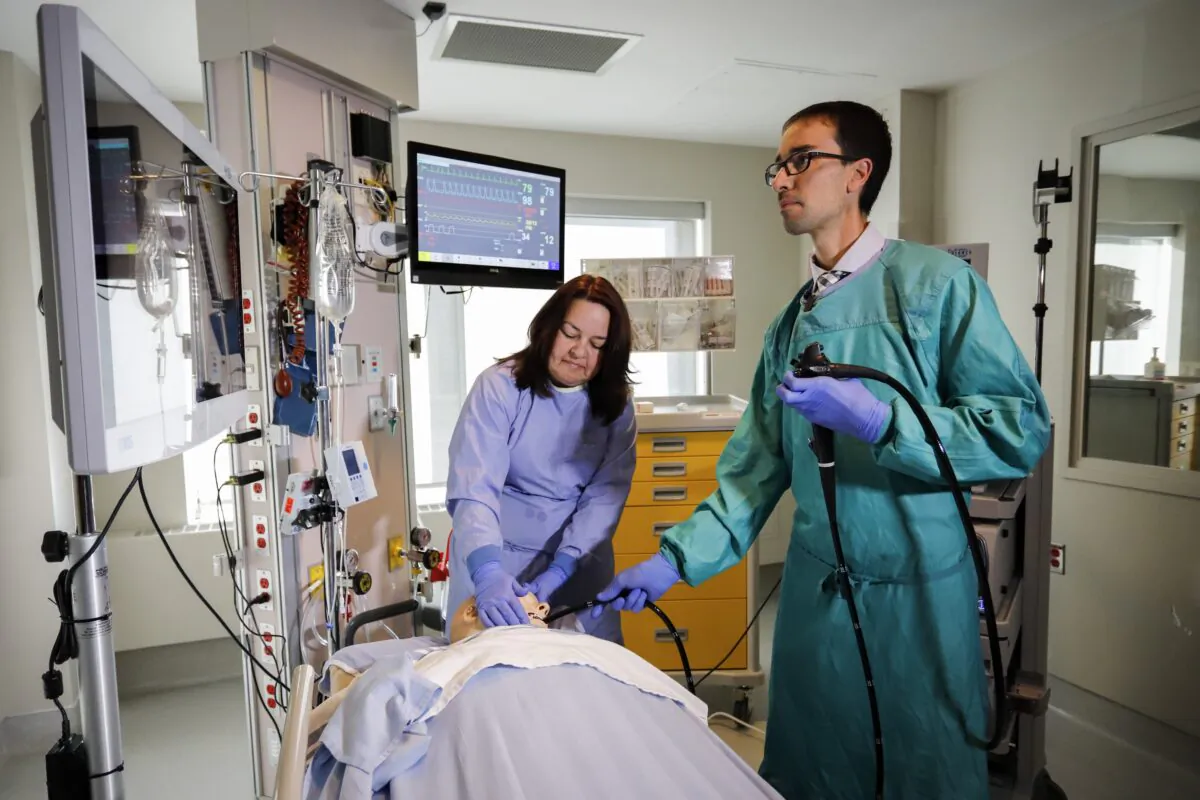 Dr. Paul Belletrutti (R) and nurse Leslie Peoples demonstrate a new surgical approach to stomach cancers at a hospital in Calgary, Alta., on March 3, 2020. (The Canadian Press/Jeff McIntosh)