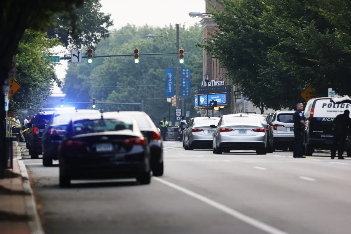 Cars and police gather around Altria Theater, the site of a shooting at the Huguenot High School graduation, in Richmond, Va., on June 6, 2023. (Mike Kropf/Richmond Times-Dispatch via AP)