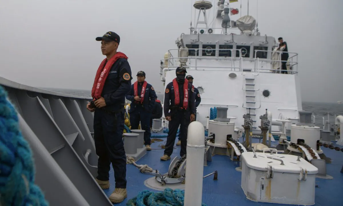 Members of the Philippine Coast Guard take part in a simulation during a trilateral maritime exercise with Japan and U.S. coast guards, 15 nautical miles off the coast of Bataan province, western Philippines, on June 6, 2023. (Jes Aznar/Getty Images)