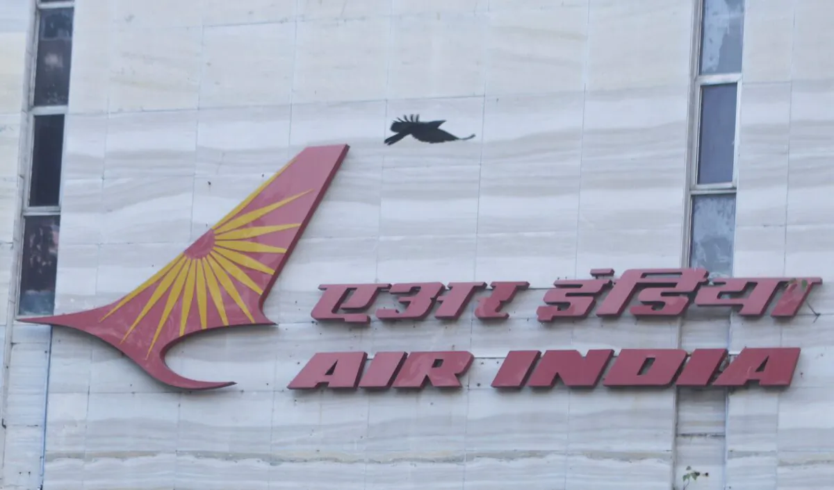 A bird flies over a logo of Air India airlines at the corporate headquarters in Mumbai, India, on Oct. 19, 2021. (Francis Mascarenhas/Reuters)