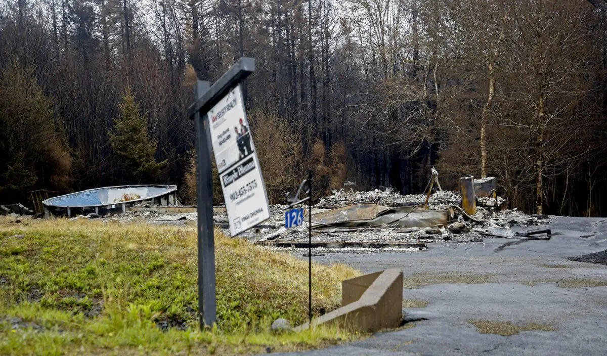 A realtor's sign on the lawn of a property destroyed by a wildfire is seen in Hammond's Plains, N.S., during a media tour, June 6, 2023. (The Canadian Press/POOL, Tim Krochak)
