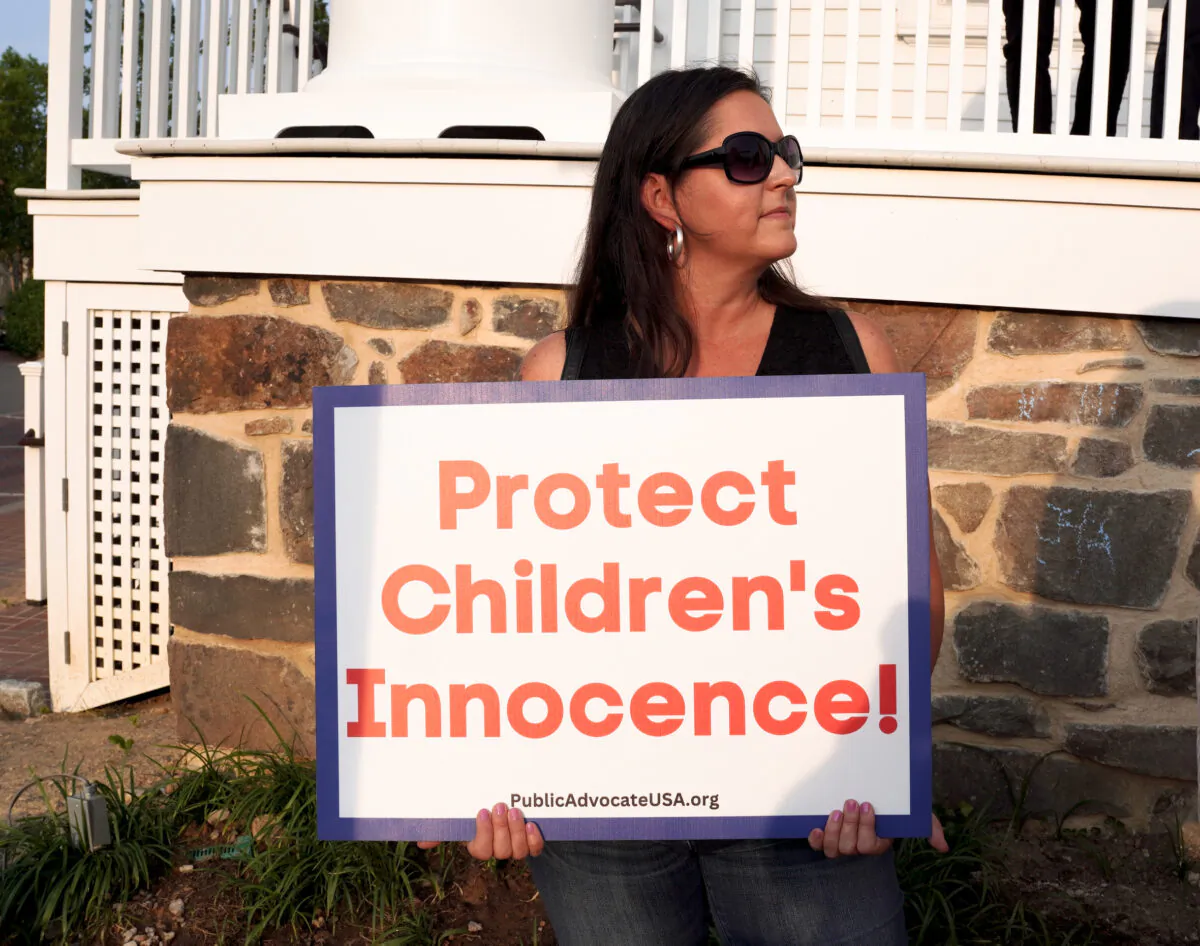 A person protests a pride month event featuring drag queen performances outside the old town hall in Fairfax, Va., on Jun. 3, 2023. (Terri Wu/The Epoch Times)