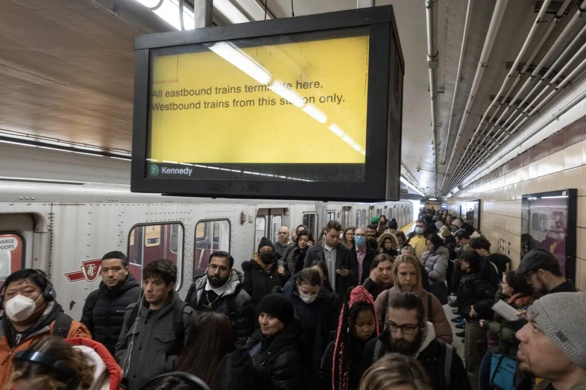 People head for shuttle buses after subway service was closed during the morning commute in Toronto, April 5, 2023. (The Canadian Press/Graeme Roy)

