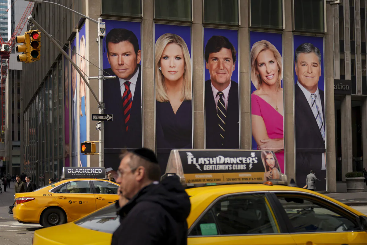 An advertisement features Fox News personalities, including Tucker Carlson and Sean Hannity, in New York on March 13, 2019. (Drew Angerer/Getty Images)