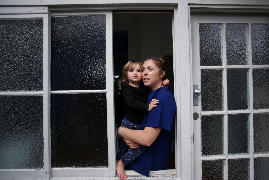 A mother sits with her daughter at her home in Bondi Beach in Sydney, Australia, on April 29, 2020. (Lisa Maree Williams/Getty Images)
