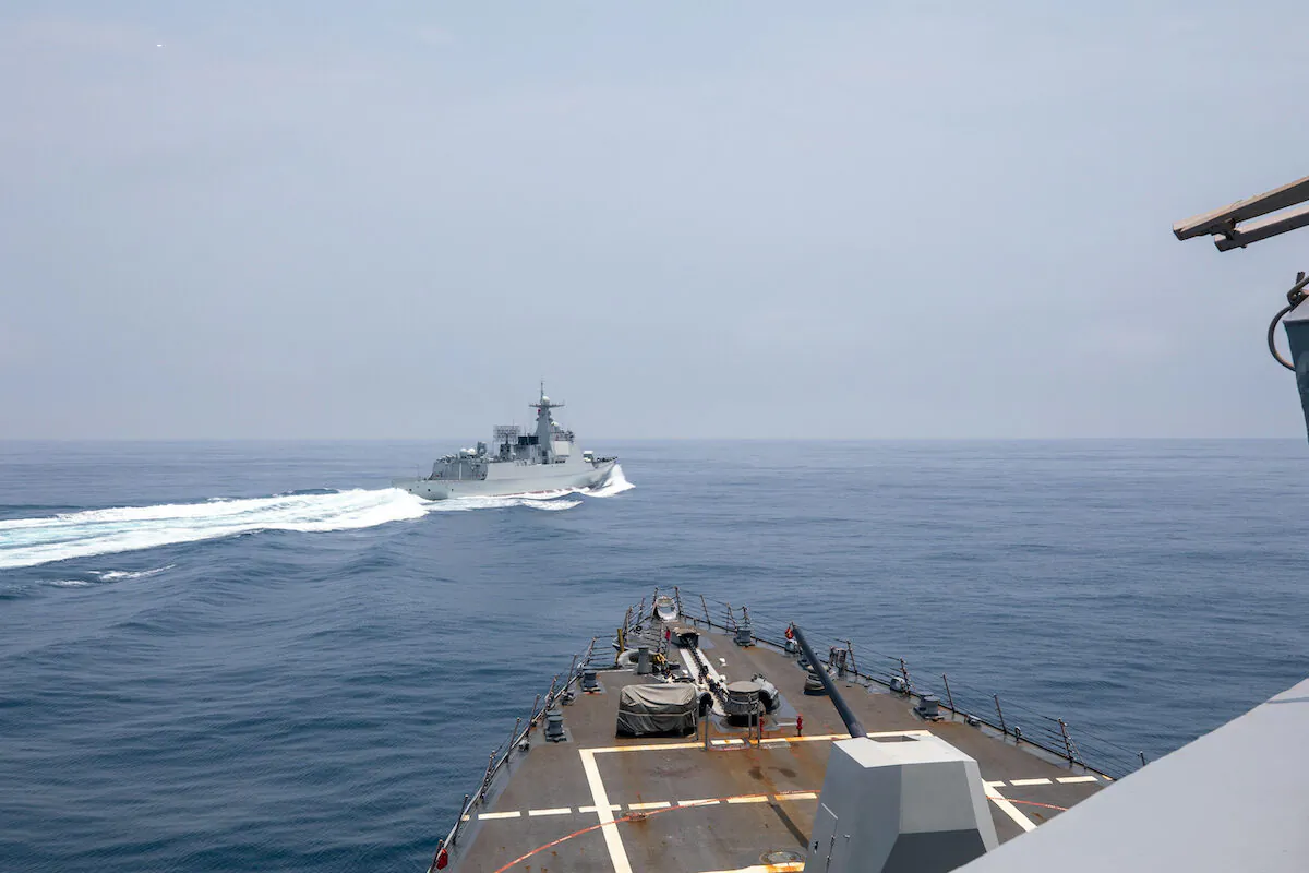 The Arleigh Burke-class guided-missile destroyer USS Chung-Hoon is observing the Chinese PLA Navy vessel Luyang III (top) while on a transit through the Taiwan Strait with the Royal Canadian Navy's HMCS Montreal, on June 3, 2023. (Andre T. Richard/U.S. Navy/AFP/Getty Images)