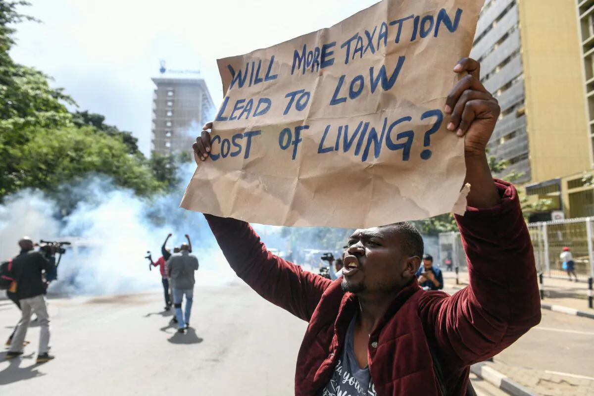 A Kenyan activist shouts amid teargas during a protest over tax hike plans in Nairobi on June 6, 2023. Kenyan police fired tear gas and arrested 11 protesters during a march in Nairobi on June 6 against a new finance bill that critics say will pile more economic hardship on ordinary people. (Simon Maina/AFP via Getty Images)