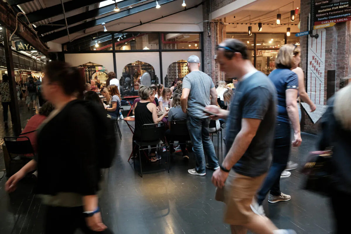 People walk through a market in Manhattan in New York on April 12, 2023. (Spencer Platt/Getty Images)