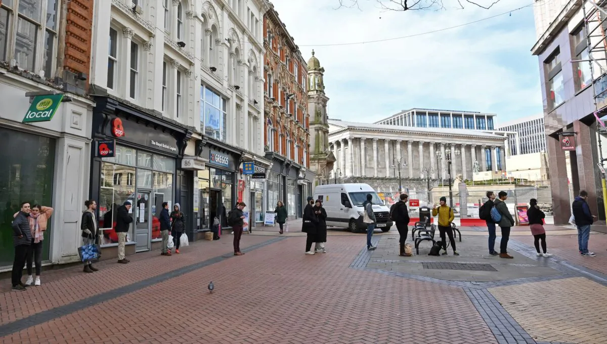 People employ social distancing as they queue for a bakery in Birmingham city centre in central England on the morning of March 21, 2020. (Justin Tallis/AFP via Getty Images)