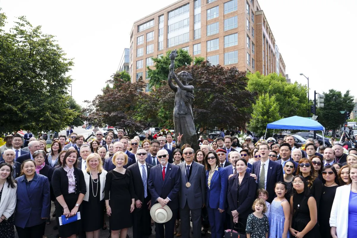 Members of various embassies, representatives of captive nations, and human rights organizations pose for a group photo at the 16th annual roll call of nations wreath-laying ceremony at the Victims of Communism Memorial in Washington on June 9, 2023. (Madalina Vasiliu/The Epoch Times)